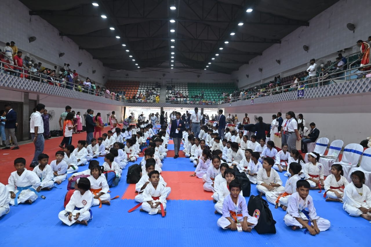 Competitors seated on the mat as the tournament gets underway